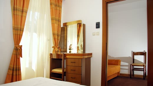 Hotel bedroom with desk and sofa